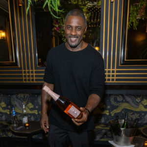 Idris Elba with a bottle of his newly launched Petite Porte Noir Rosé Champagne